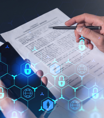 Hand with a pen and phone on a document with security icons