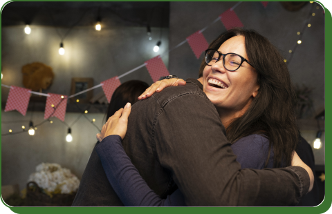 Two people hugging and laughing